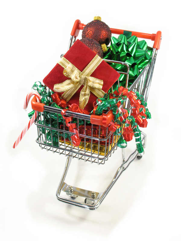 Mini shopping cart filled with red and green holiday ornaments, packages and ribbons