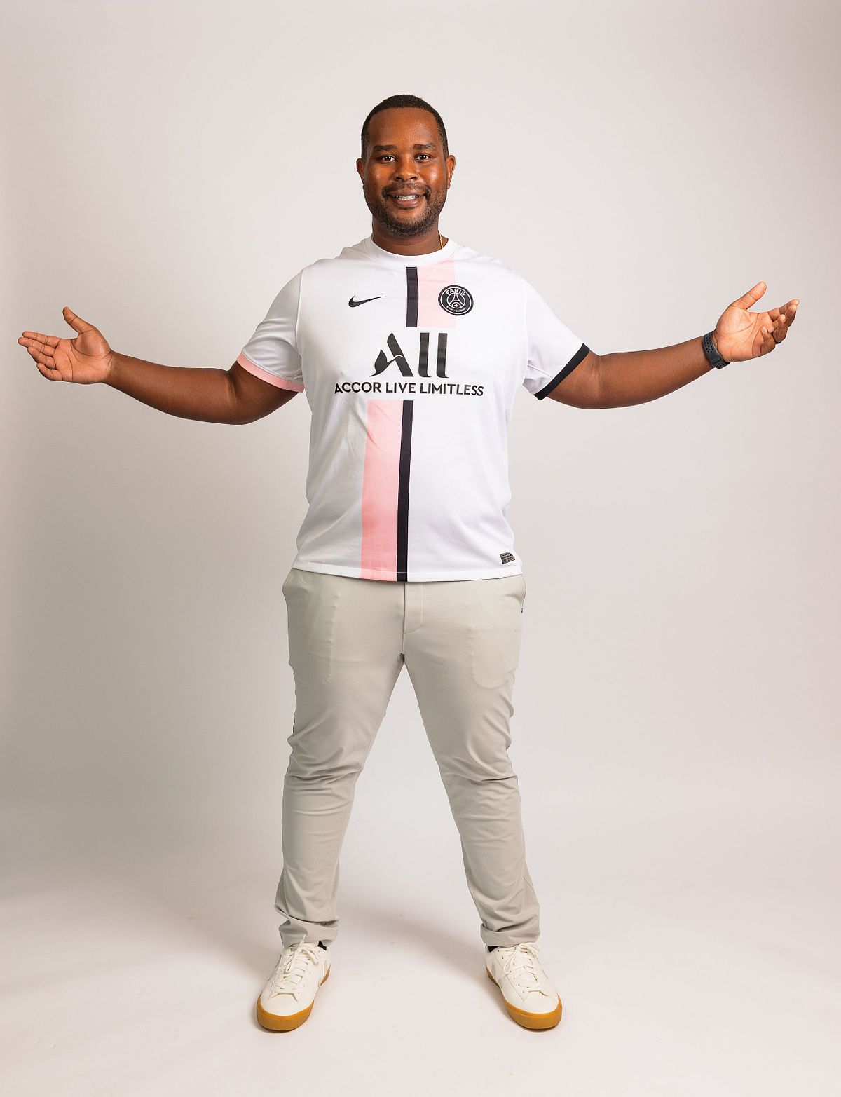 A full-body photograph of a man with outstretched arms against a white backdrop at Innovate Carolina's offices in Chapel Hill, NC