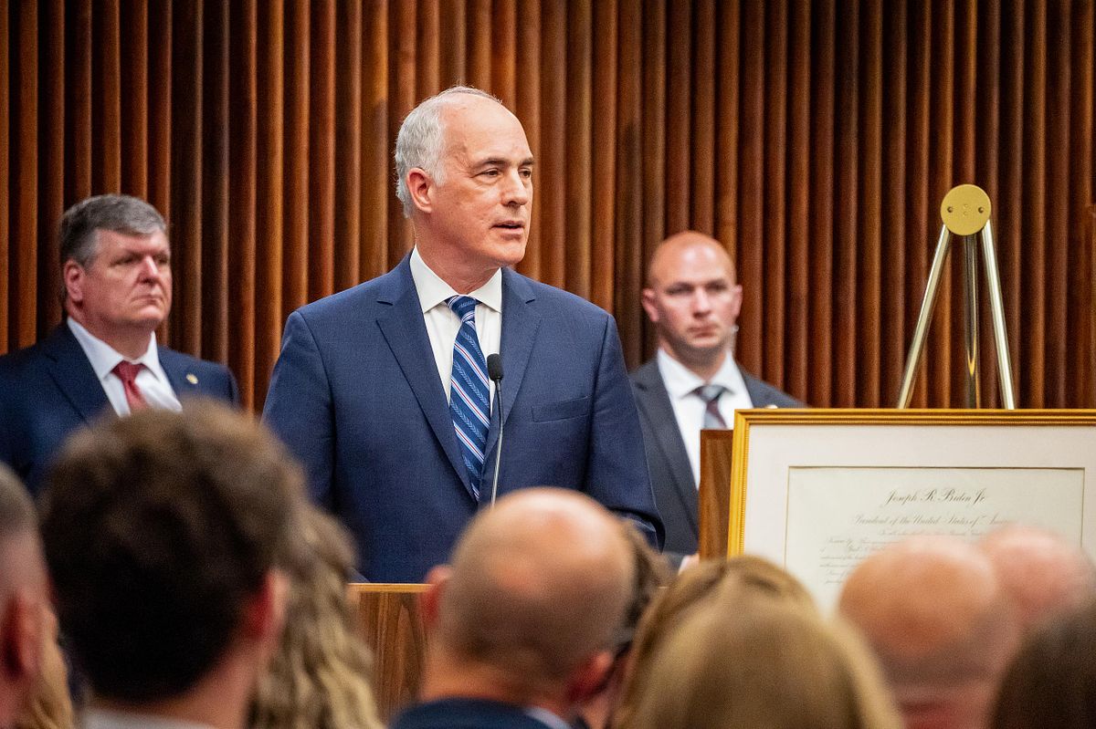Corporate event photography capturing a U.S. Senator delivering remarks during Judge Gail Weilheimer’s investiture ceremony in Philadelphia, emphasizing leadership, public service, and meaningful civic connection.