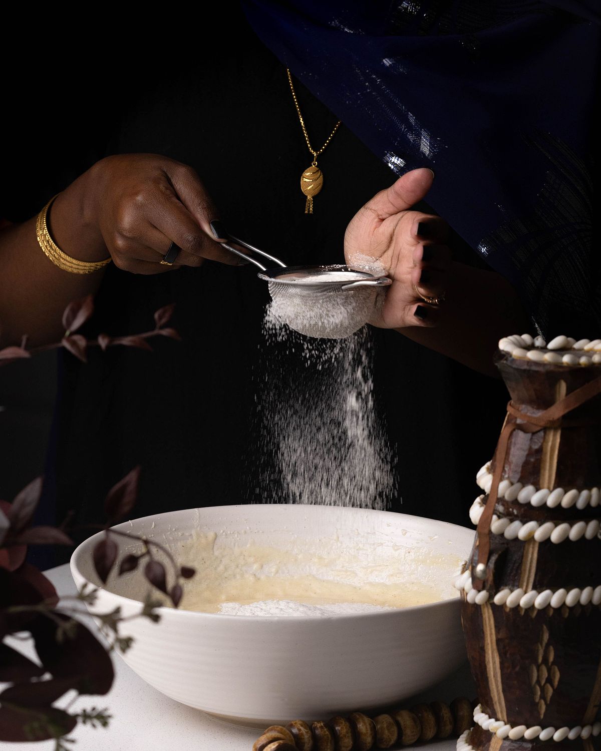 Somali lady sifting flour into a bowl