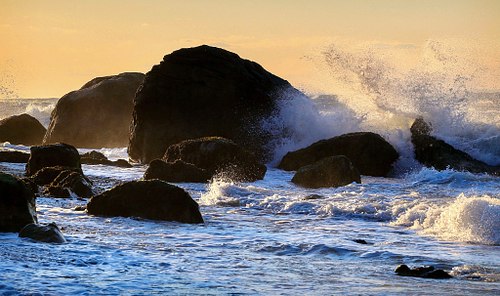 Crashing Waves on shoreline rocks.