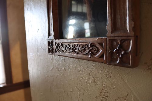 the carving on the lower rail of the carved frame for the Immaculate Heart