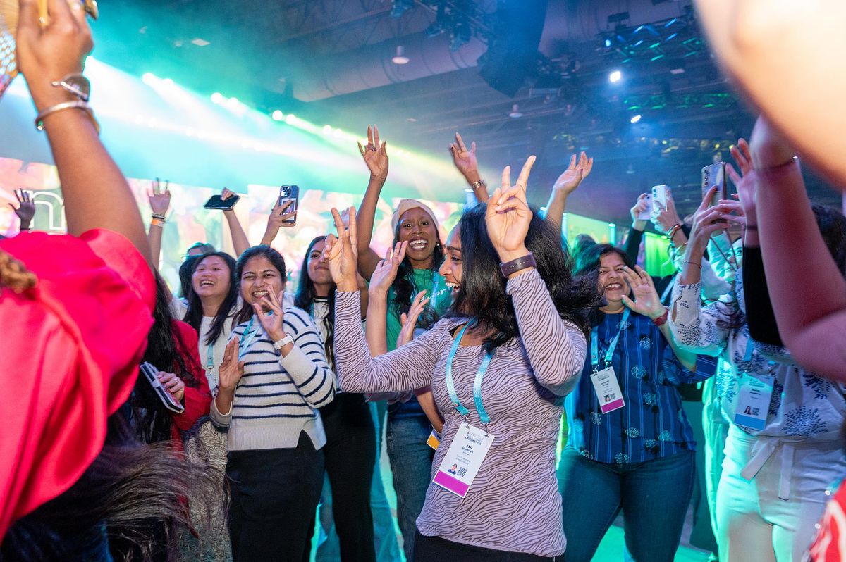 Corporate event photography capturing Grace Hopper Celebration attendees dancing and celebrating during an after-hours event in Philadelphia, highlighting joy, community, and connection.