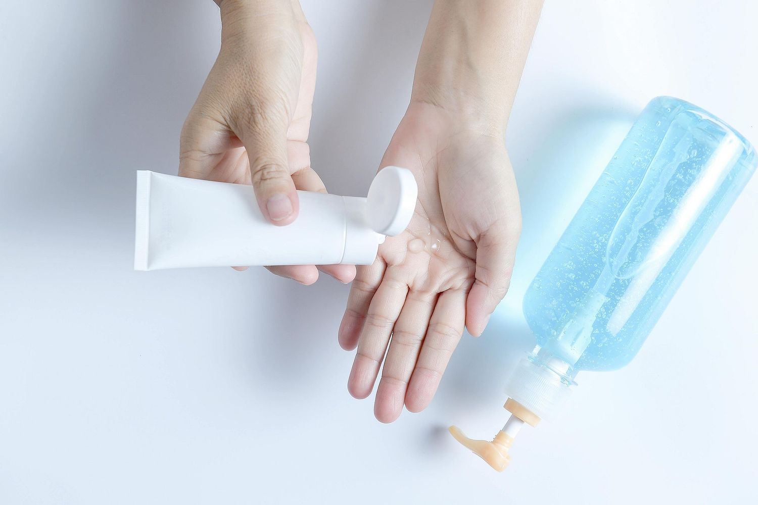 image of a woman applying hand lotion to hear hand