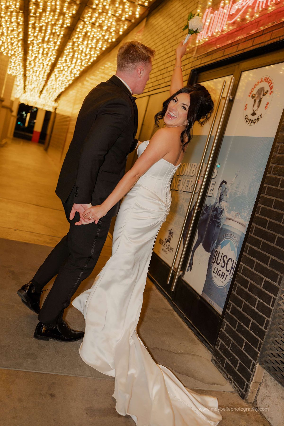 Romantic elopement photos at Carousel Bar in Downtown Las Vegas with couple celebrating with champagne