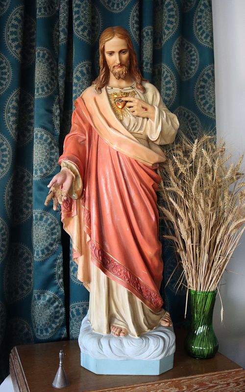 Shows the Sacred Heart Statue before restoration.