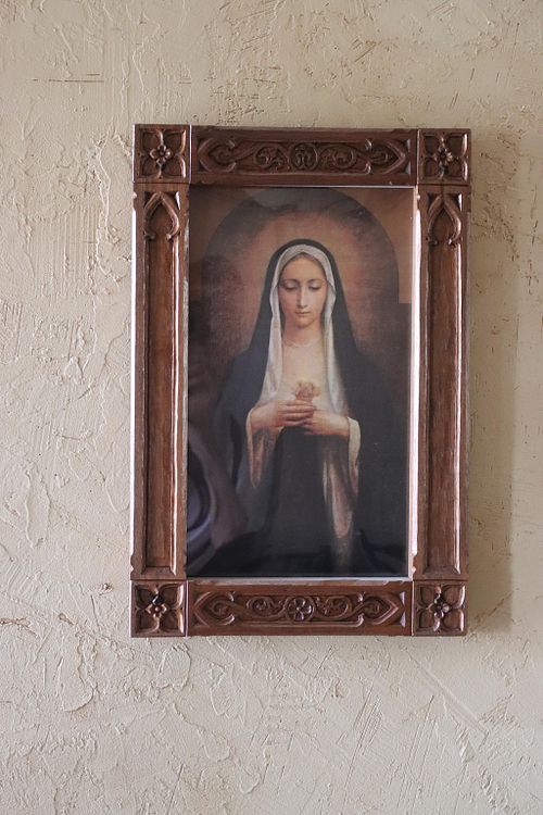 a walnut picture frame hand-carved in Gothic style for a picture of the Immaculate Heart of Mary