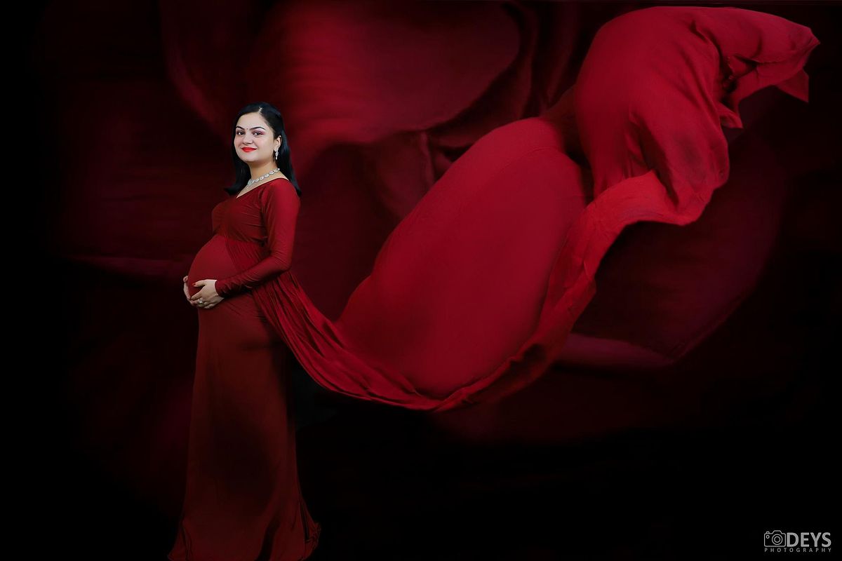 Red gown studio maternity photos in Delhi