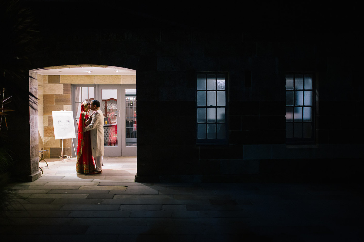 Classic wedding portrait of the couple kissing in front of a historic Gunners Barracks Mosman.