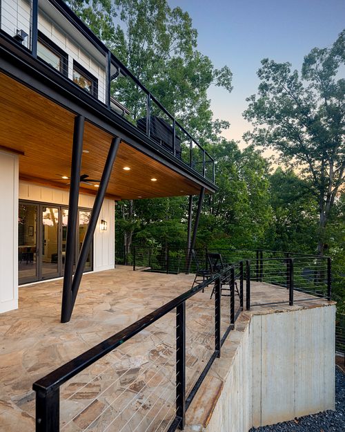 'V' posts anchoring down to covered stone patio