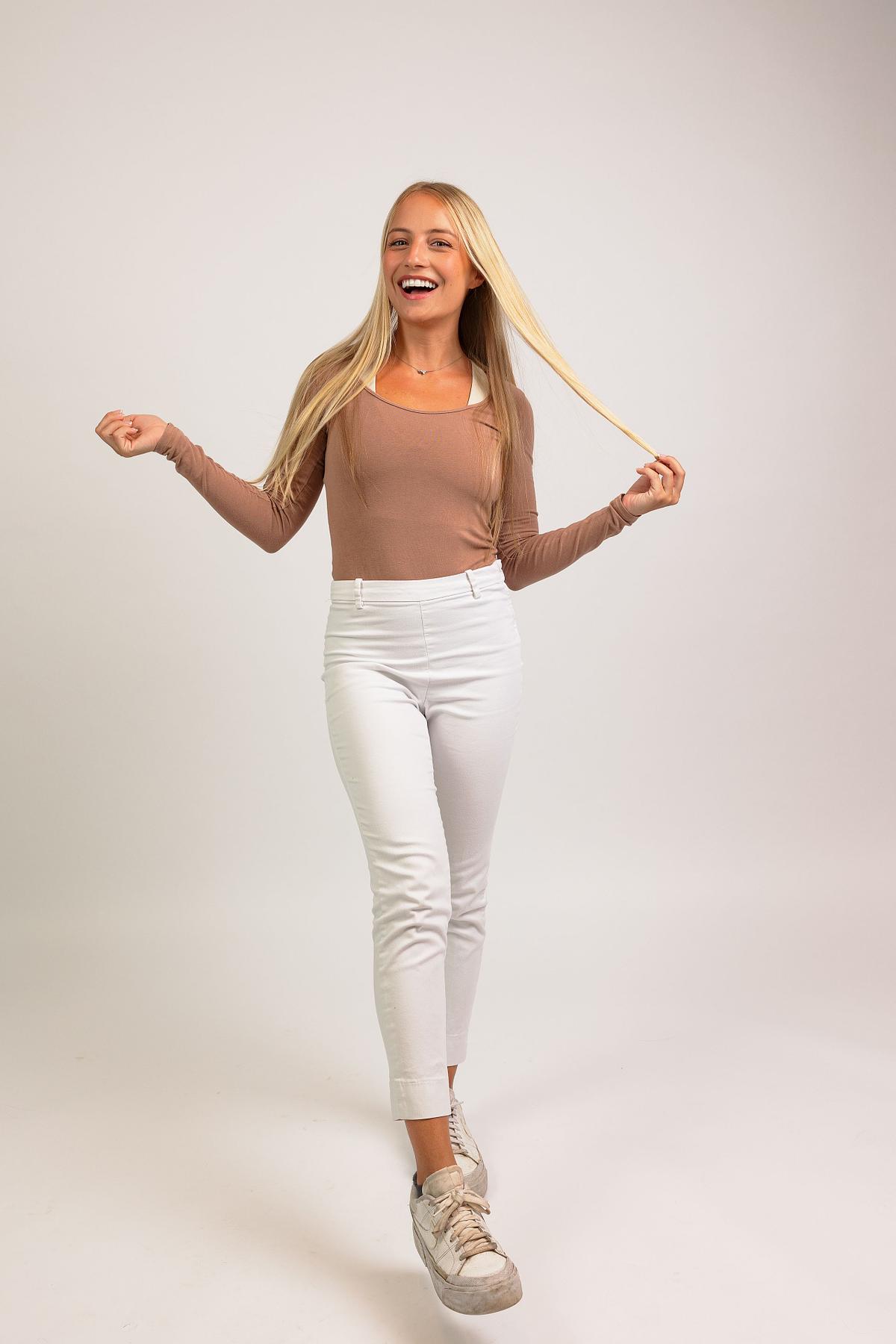 A full-body photograph of a woman against a white backdrop at Innovate Carolina's offices in Chapel Hill, NC