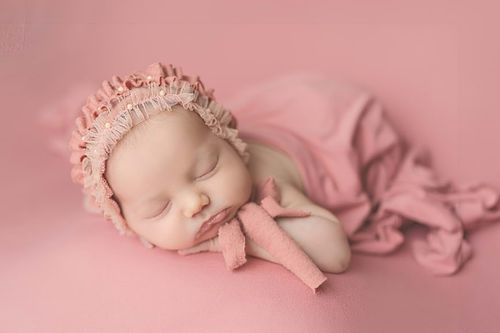 Newborn baby girl wrapped in pink swaddle – Houston newborn photographer Amanda Mandola