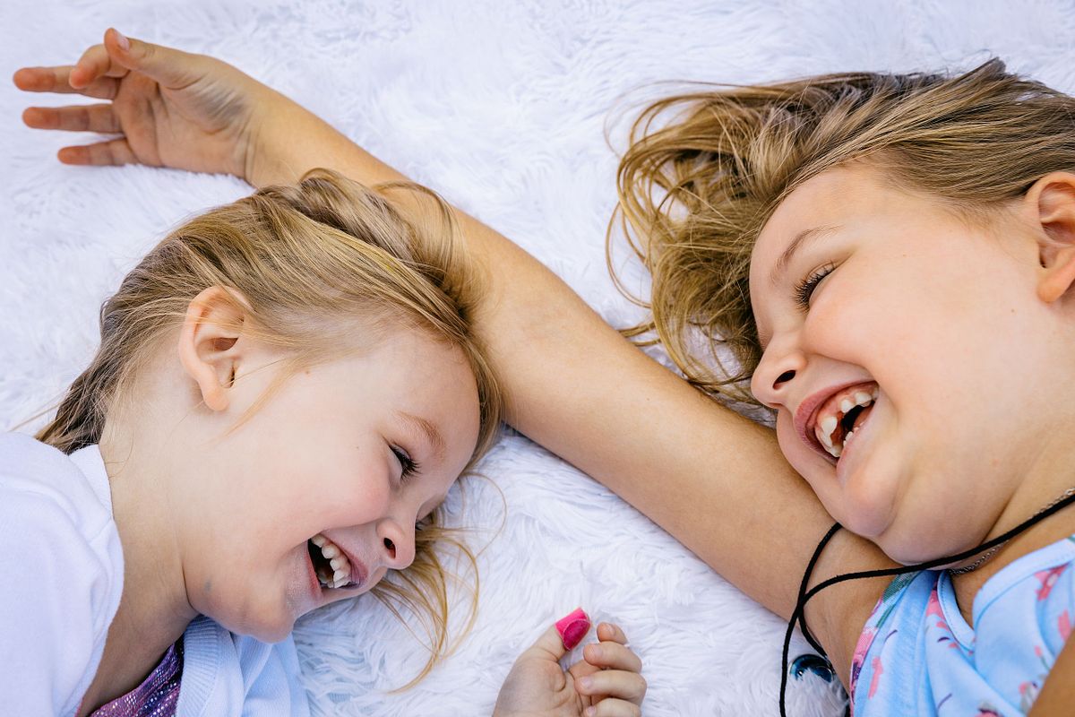 Two girls on a blanket at American Tobacco Campus in Durham, NC