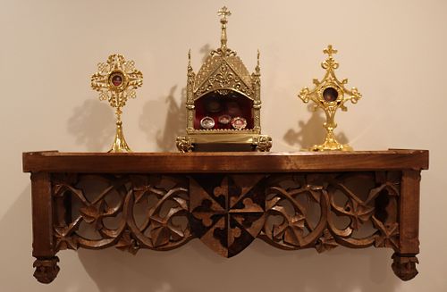 the shelf after installation holding various reliquaries owned by the Dominican Sisters