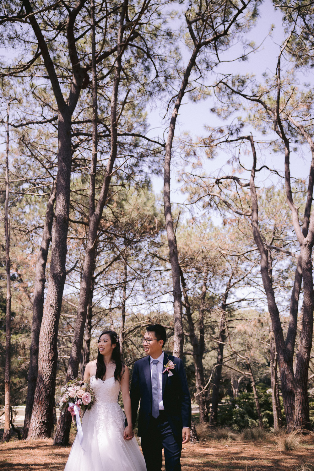 Candid wedding photo of the bride and groom at She Oak Grove, Centennial Park.