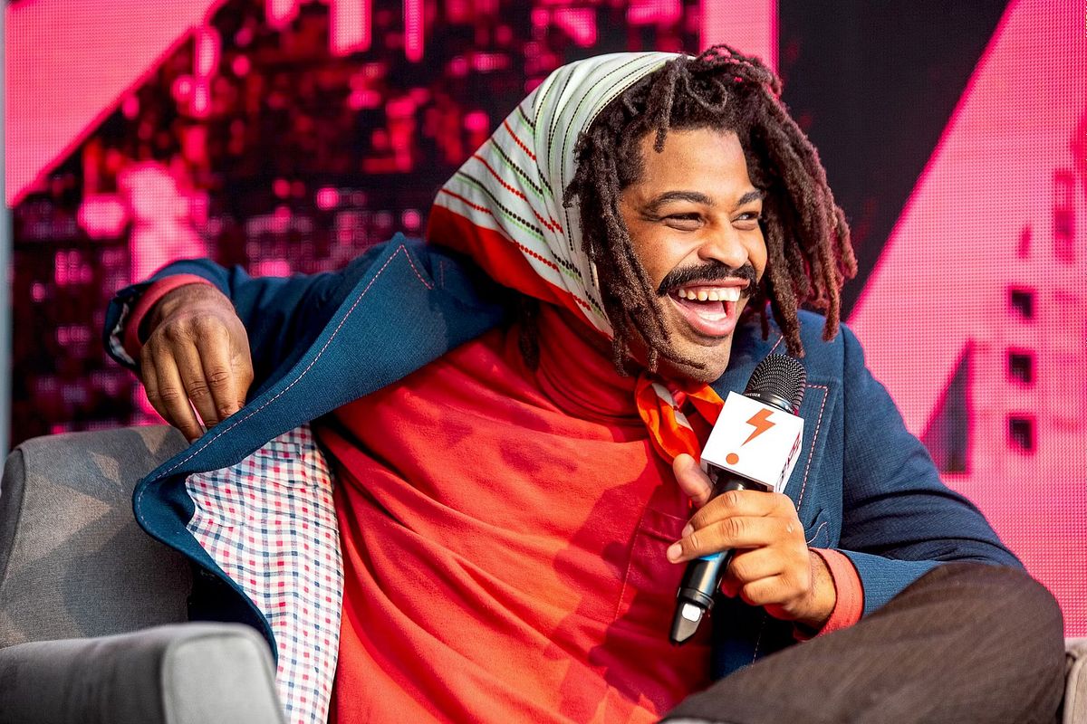 Corporate event photography capturing a dynamic speaker participating in a panel discussion at B.PHL Fest 2023 in Philadelphia, emphasizing leadership presence, authentic connection, and community-focused dialogue.