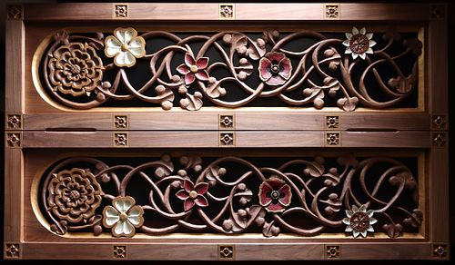 Carved door panels with vines and symbolic flowers related to the Sacred Heart of Jesus: Dogwood, Passionflower, Begonia, and Poppy
