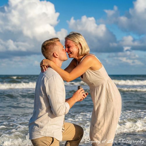 Close up of a woman’s emotional reaction during a surprise beach proposal in Jacksonville by Legacy of Love Photography.