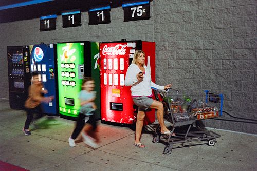 35mm film photo of kids running outside a Walmart