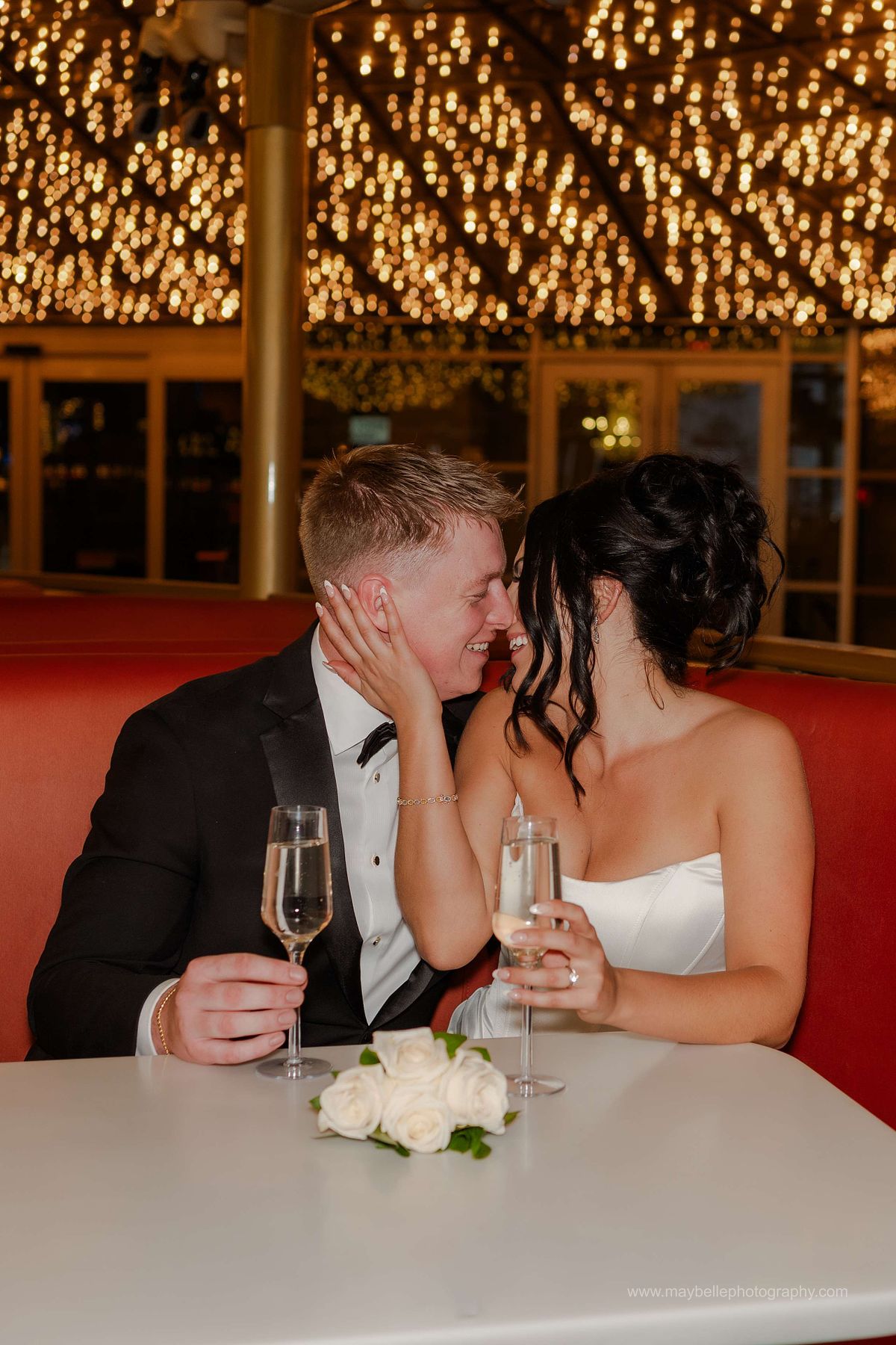 Romantic elopement photos at Carousel Bar in Downtown Las Vegas with couple celebrating with champagne
