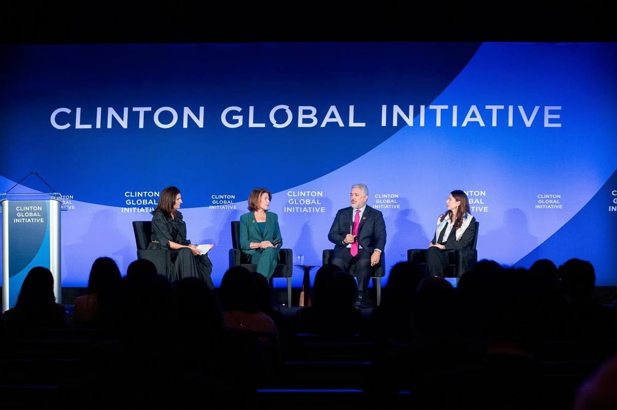 Annual meeting photography showing a leadership panel on stage with audience members during a major institutional event.