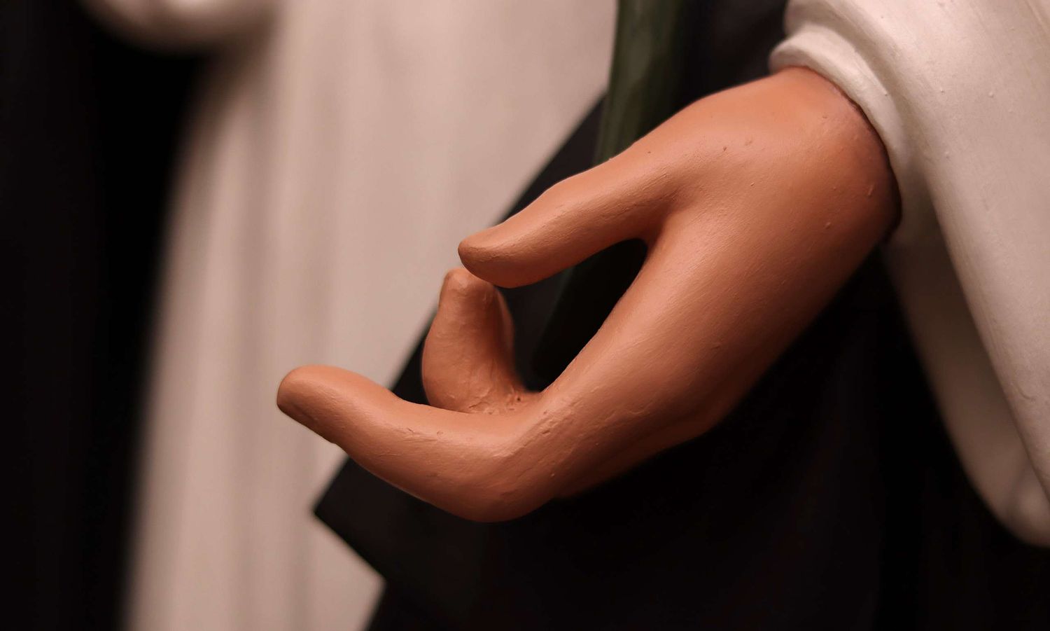 Saint Dominic statue's hand after repair and repainting.