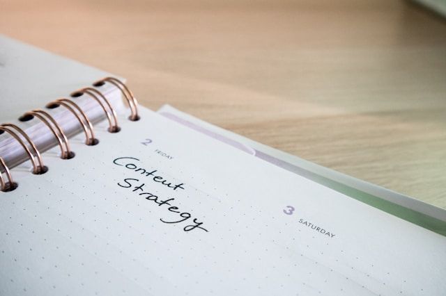 Desk with a planner with the words Content Strategy on it