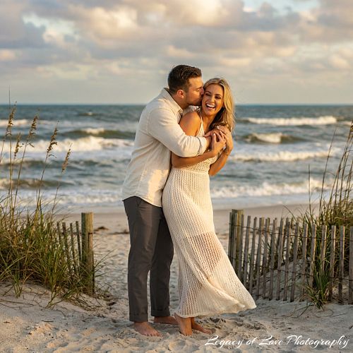 Couple embracing on a Jacksonville beach during a golden hour sunset proposal by Legacy of Love Photography.