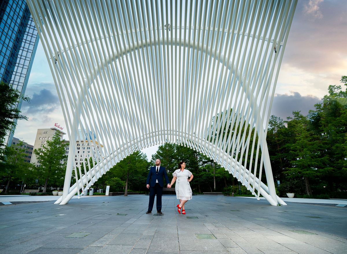 Engaged couple sharing a candid moment during golden hour in Oklahoma.
