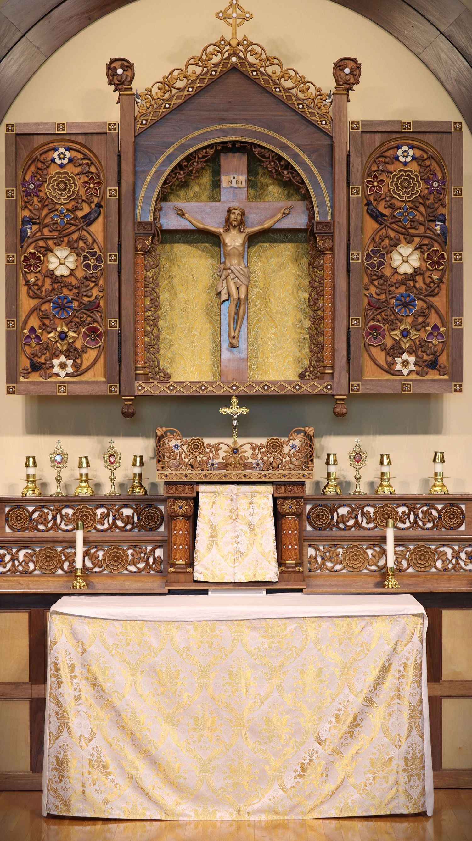 Hand carved altarpiece at St. Bernadette Catholic Church in Lancaster, Ohio.  Covered with intricate carvings of birds, vines, and flowers.