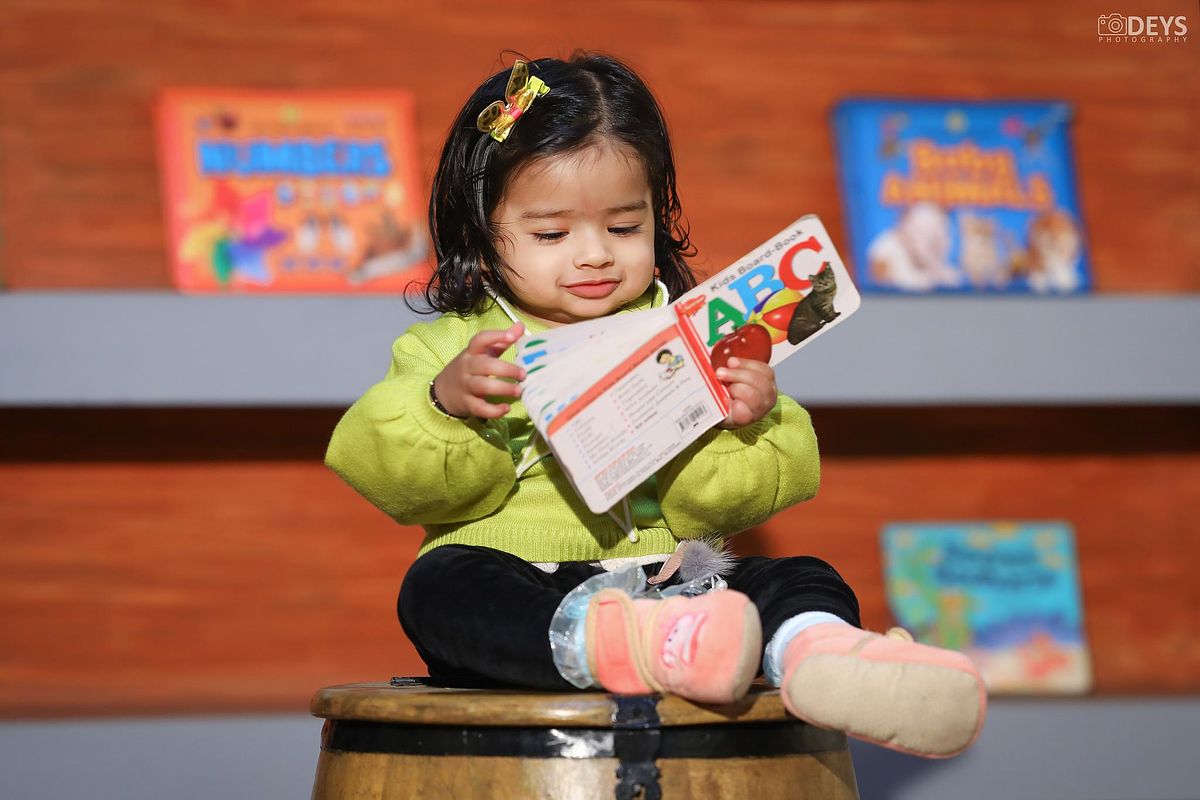 Baby reading photography at studio