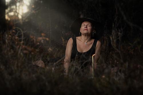 A witch enjoys the light leaking into her grove.