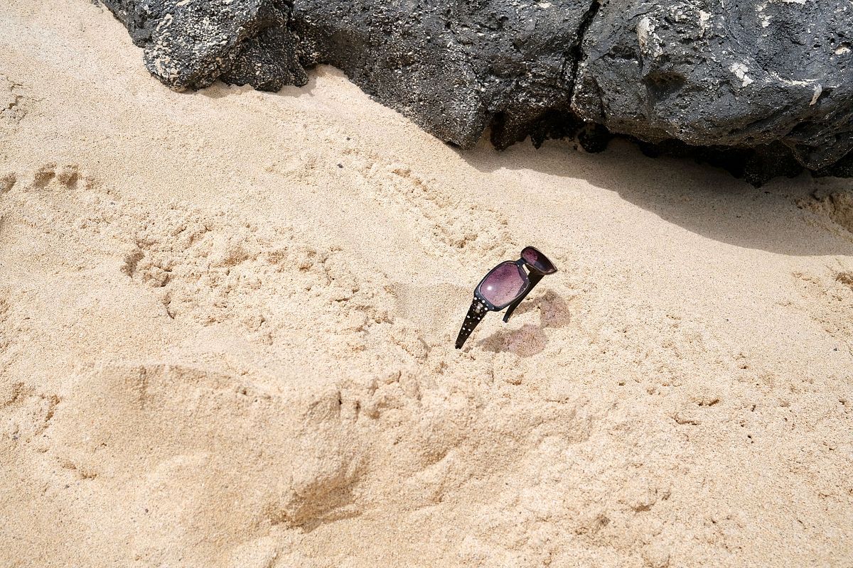 Sunglasses left in the sand in Oahu, Hawaii