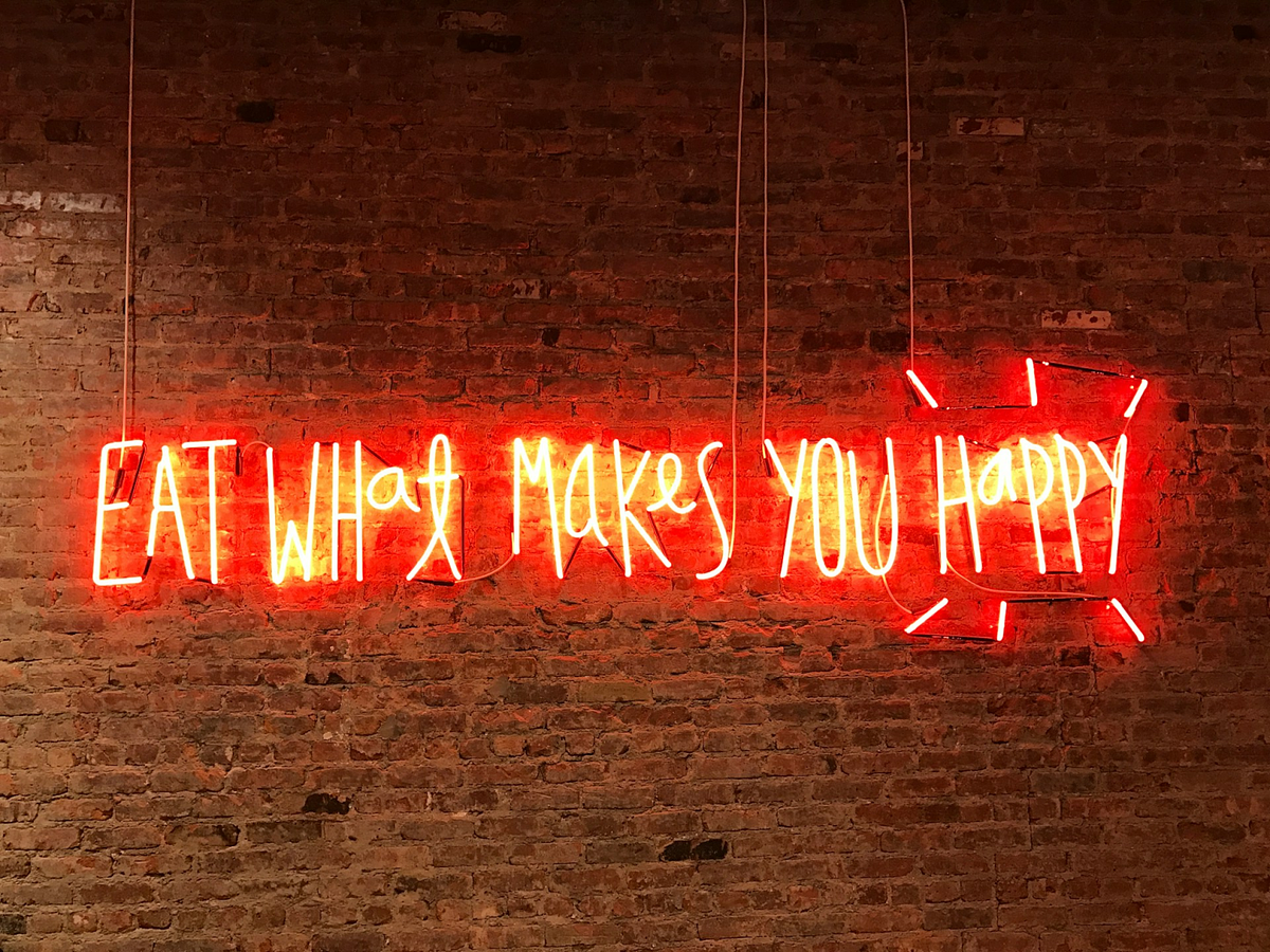 Neon sign on a rustic brick wall