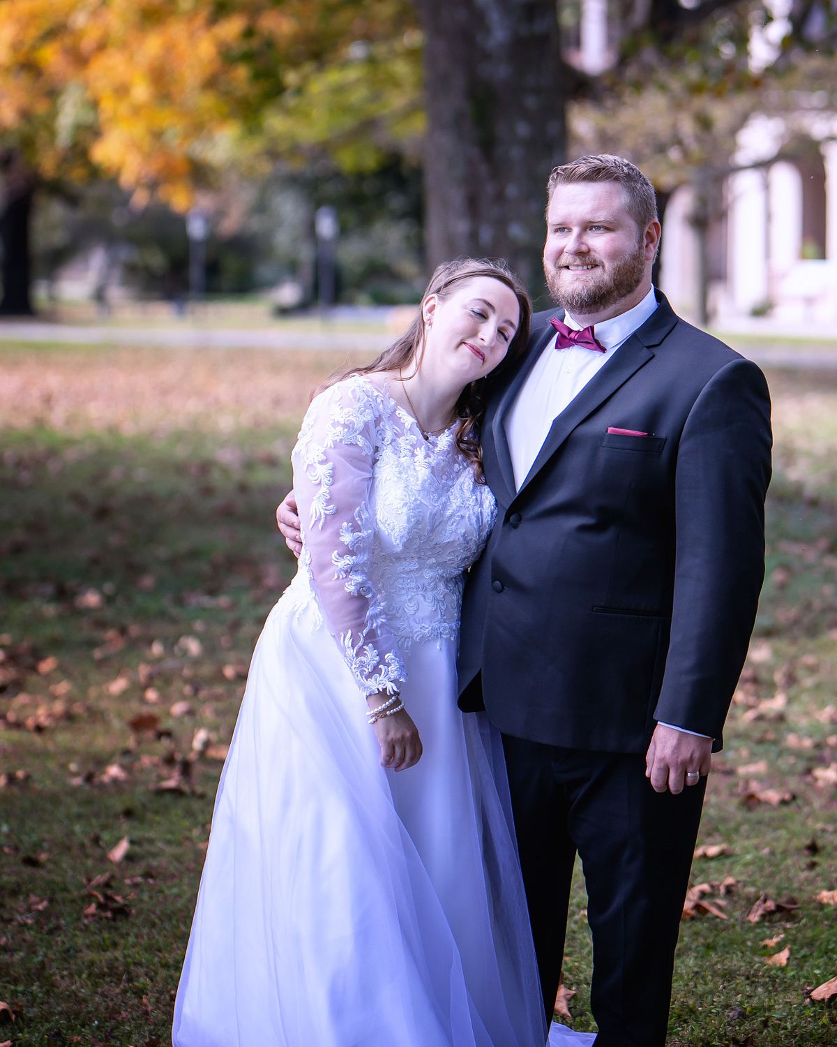 bride and groom posing in front of the ross mansion in seaford, de, in autumn