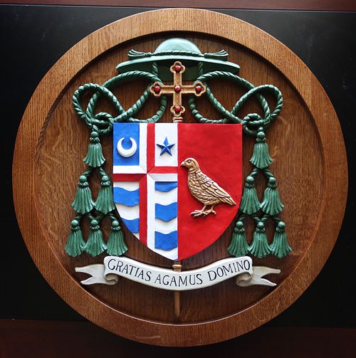 hand-carved and painted coat of arms for Bishop McKnight of Jefferson City, Missouri with traditional Catholic symbolism