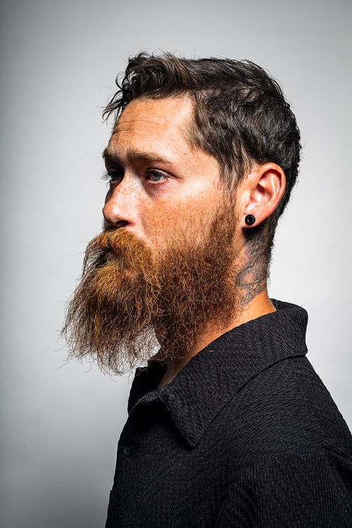 Smiling studio portrait of Tim with softbox and strobe lighting on white background — lifestyle portrait by David Andrade, Las Vegas