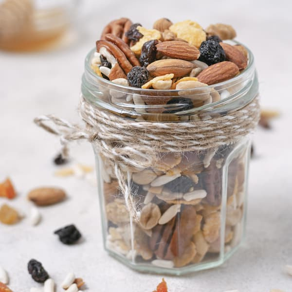 jar of trail mix with mixed nuts and raisins