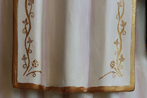 Gold floral trim on the white scapular on the restored St Rose statue