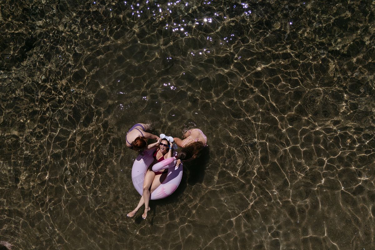 bride with bridesmaids in the sea during pre wedding session in Sifnos Cyclades Greece