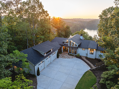 Birdseye view of the home with a view of the lake beyond