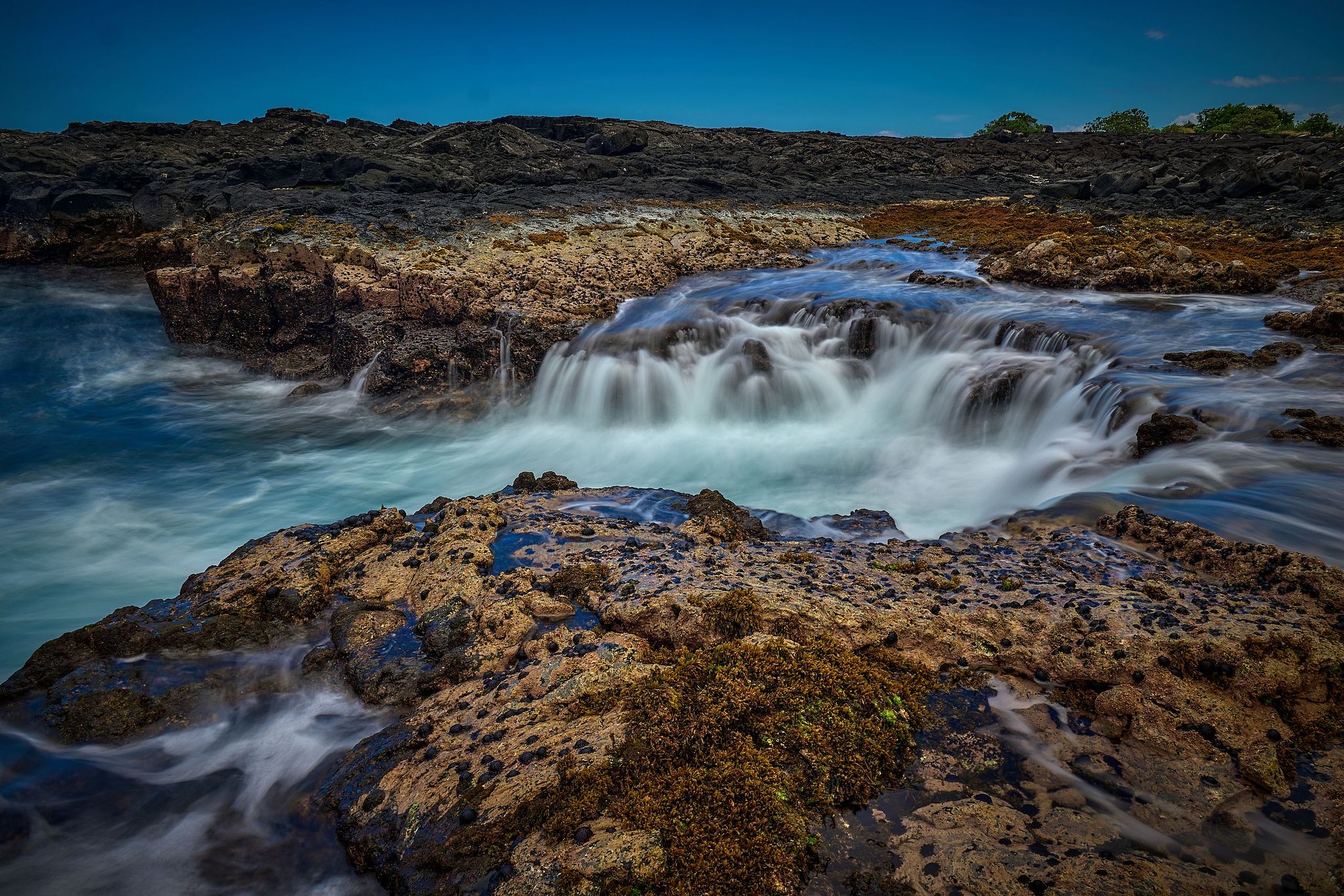 Waterfall Reverses With Each Wave - Wawaloli Beach, Hawaii