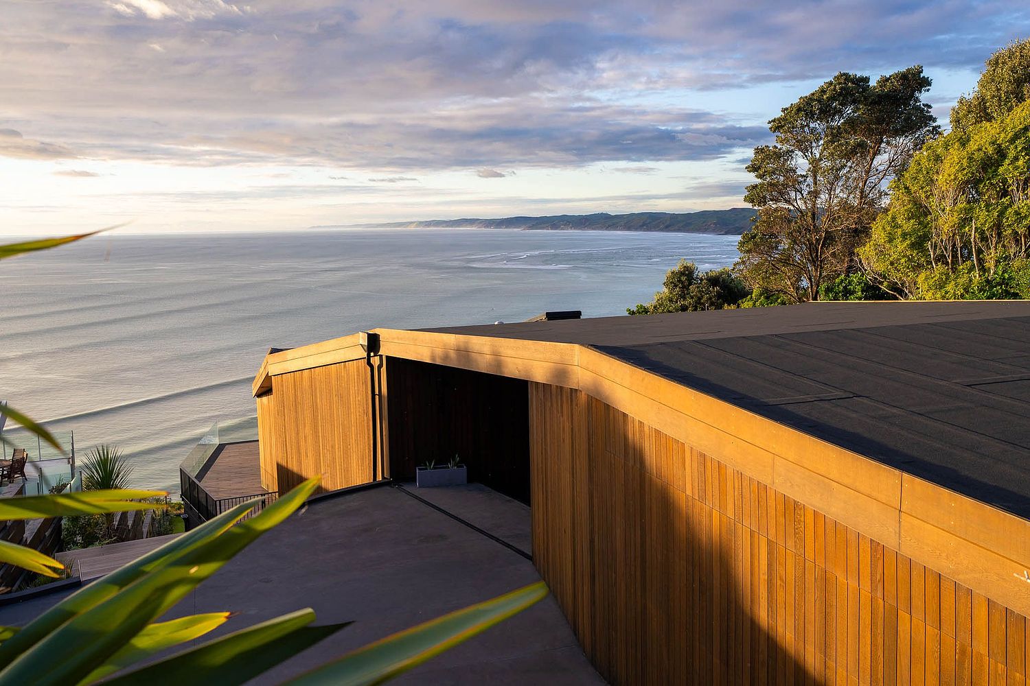 Luxury coastal architectural photography overlooking Manu Bay Raglan by Flax Cove Studio.