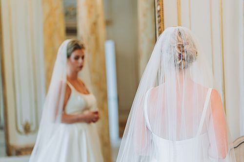 Bride looking in mirror