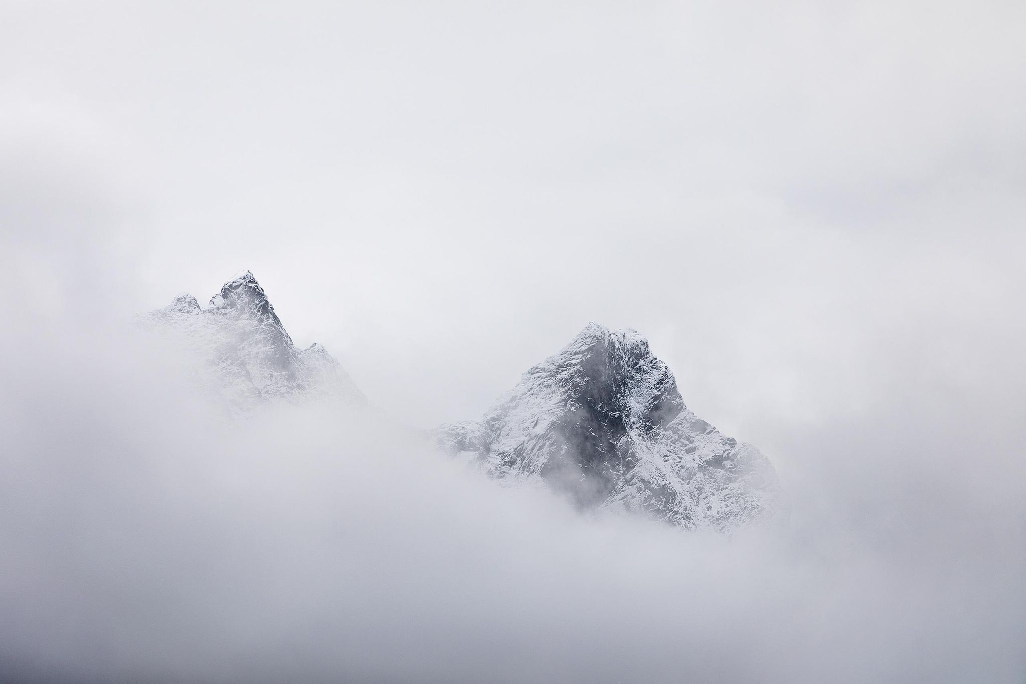 Minimalist mountain ridges emerging through mist, fine art landscape photography by Florent Baudy