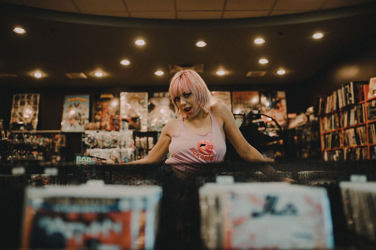 Retro boudoir session set inside a vintage record store with moody, nostalgic vibes.