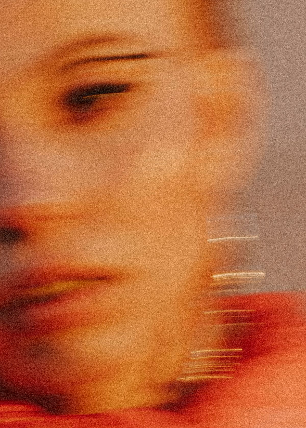 Blurred portrait of a female model with statement eyeliner. Photographed by Filianna Karamanli.