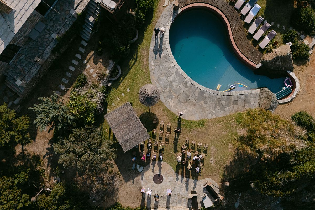 epic drone wedding photography in Syros Cyclades Greece with aerial views of coastline and couple &ndash; destination wedding photographer