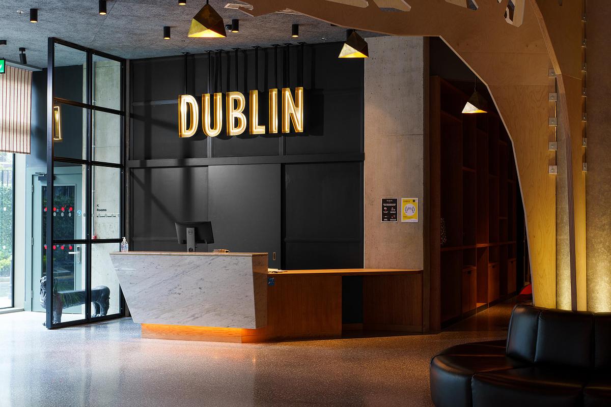 Interior photograph of the reception area at the Marlin Hotel Dublin, featuring a prominent "DUBLIN" sign and modern design