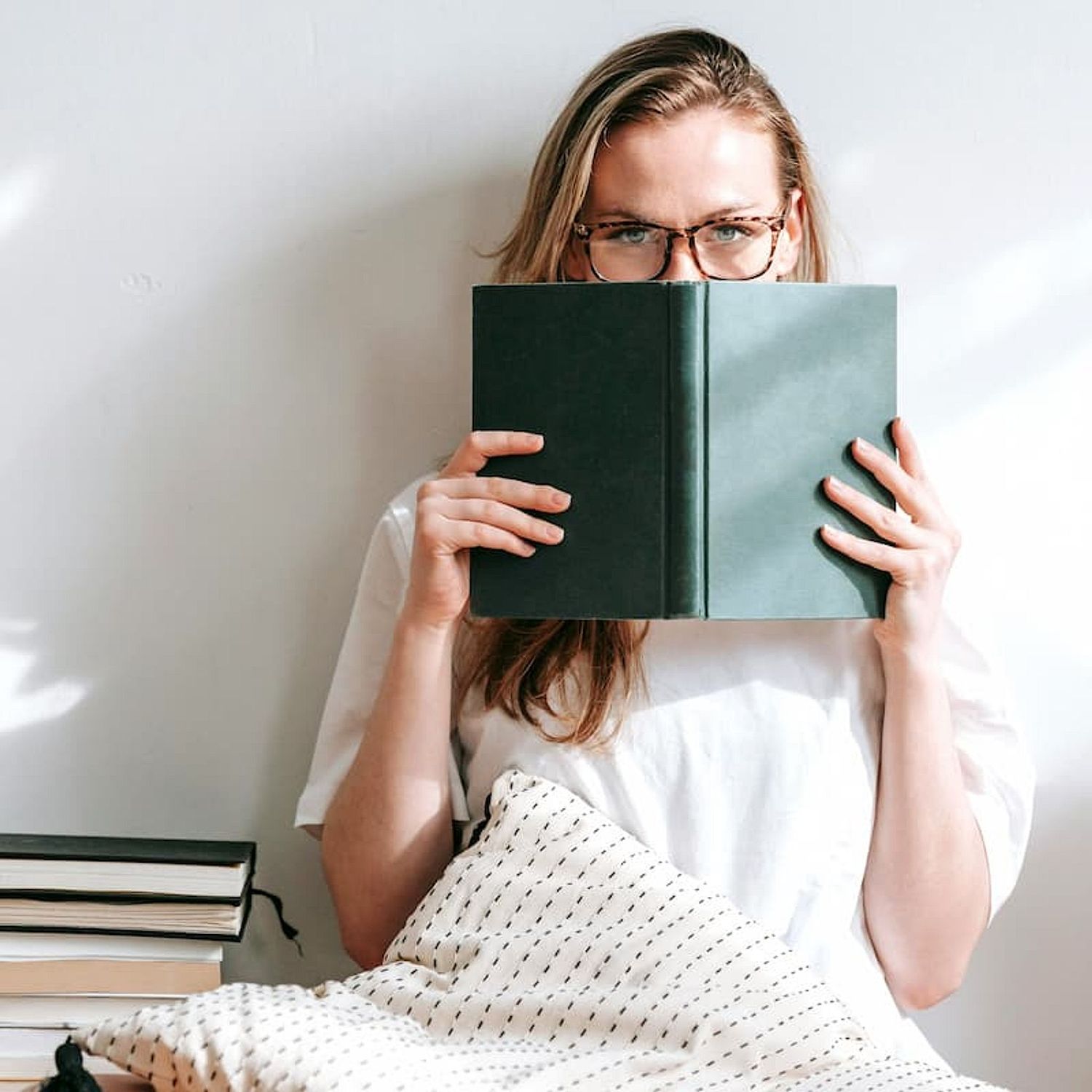 Menopausal woman reading book about HRT while sitting comfortably